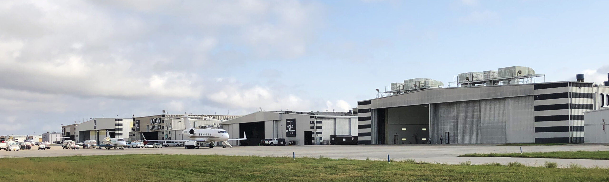 line of hangars with planes in front at Lincoln airport